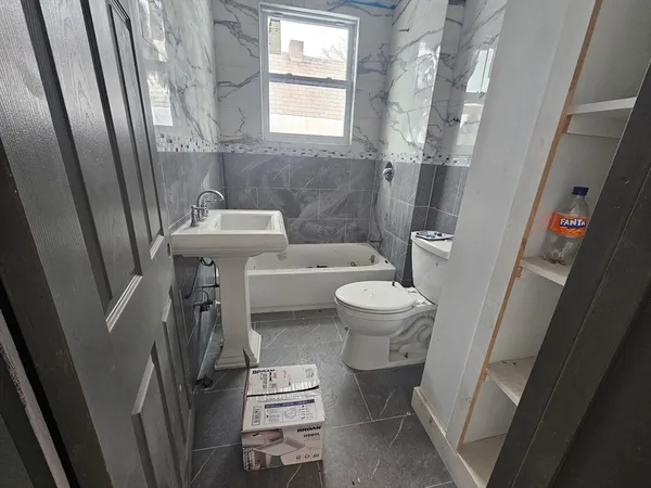 a bathroom with a sink toilet and shower