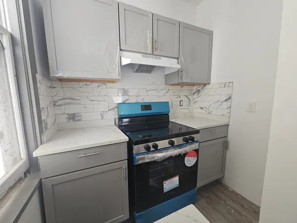 a kitchen with a stove and a microwave