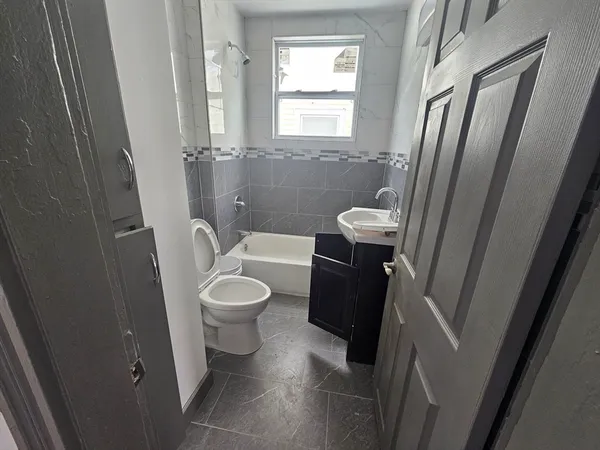 a bathroom with a toilet a sink and a mirror