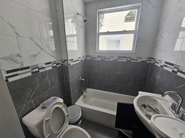 a bathroom with a sink a toilet and bathtub