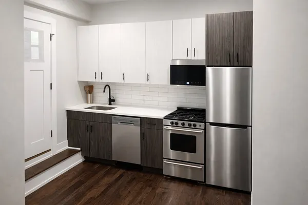 a kitchen with stainless steel appliances a stove a microwave and a refrigerator