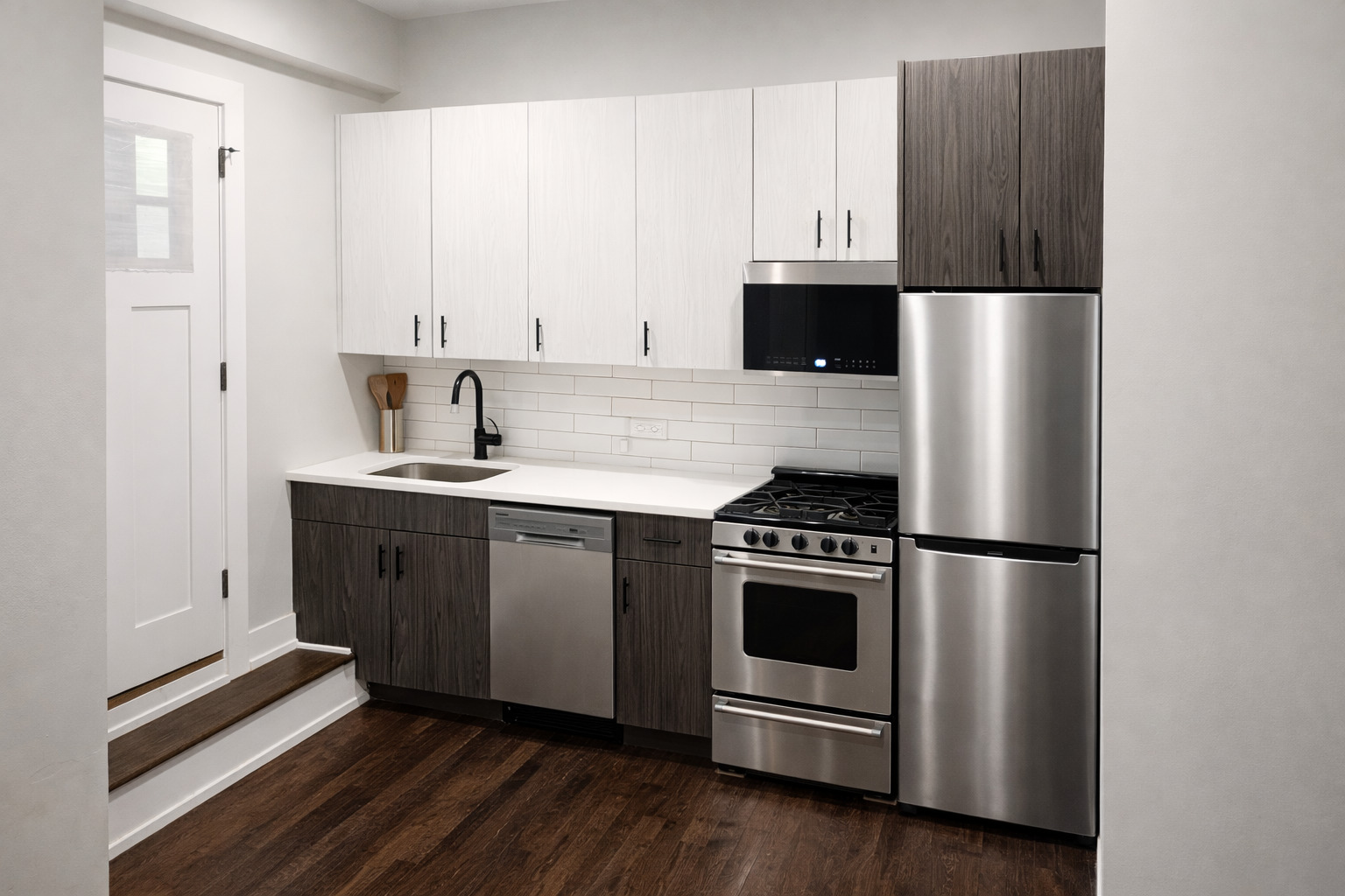 2957 North Milwaukee Avenue, Unit S2 Chicago, IL 60618 - Photo 2 of 6 a kitchen with stainless steel appliances a stove a microwave and a refrigerator