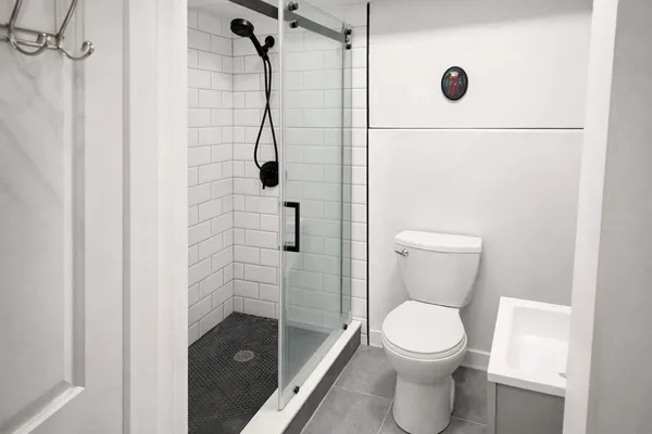 a bathroom with a toilet and a shower