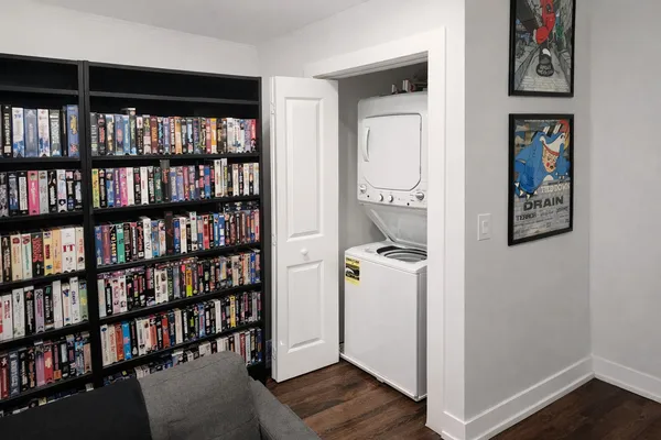a room with a book shelf and a window