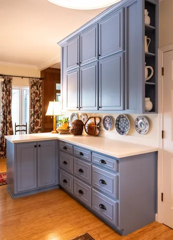 a kitchen with a refrigerator and a stove top oven