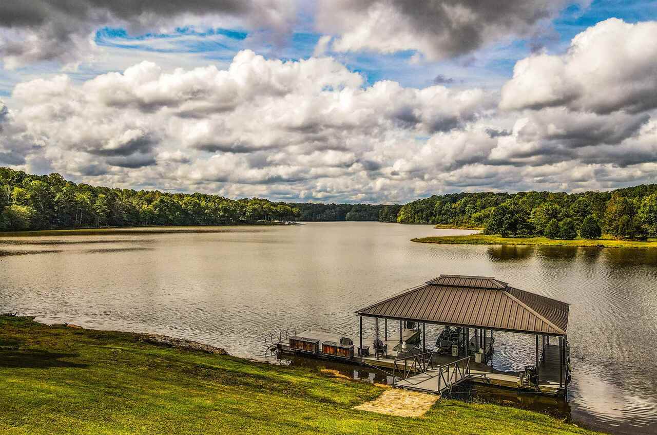 183 Madden Road Bowdon, GA 30108 - Photo 64 of 79 a view of a lake with a table and chairs