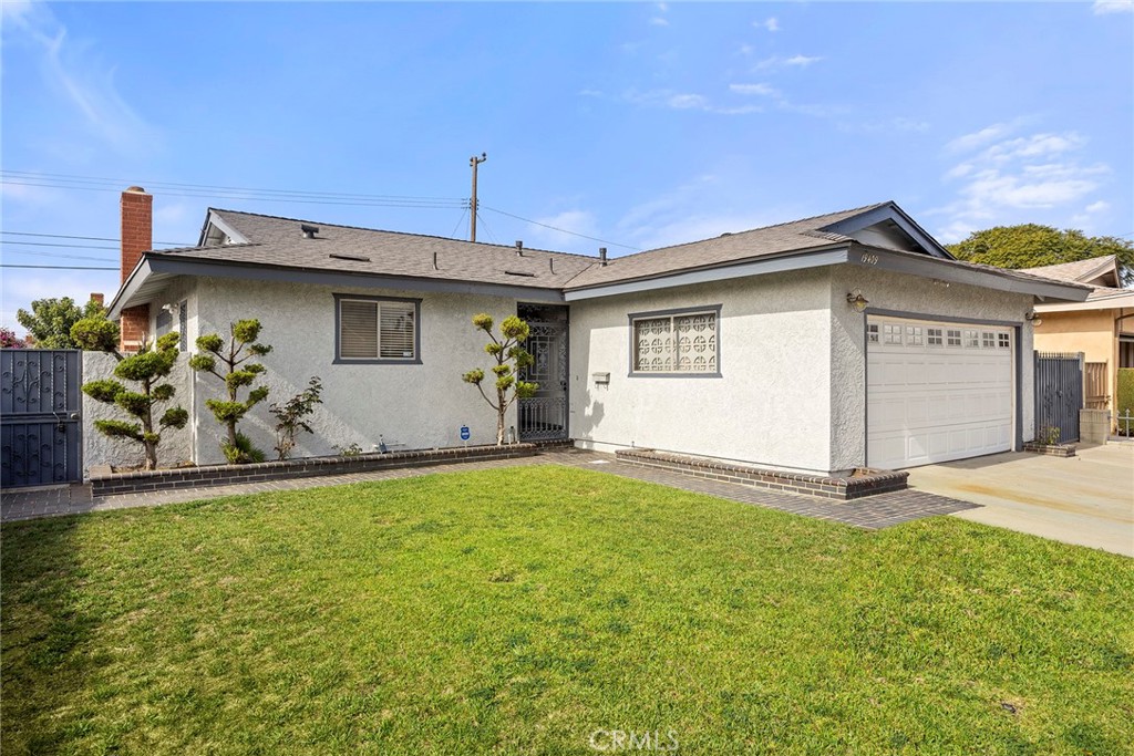 19409 Belshaw Avenue Carson, CA 90746 - Photo 1 of 15 a front view of a house with a yard and garage