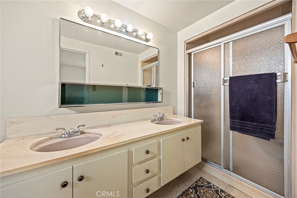 19409 Belshaw Avenue Carson, CA 90746 - Photo 12 of 15 a bathroom with double sink and a mirror