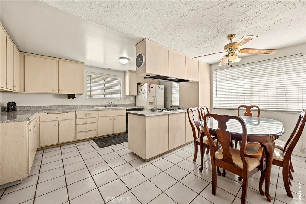 19409 Belshaw Avenue Carson, CA 90746 - Photo 8 of 15 a kitchen with a table chairs and white appliances