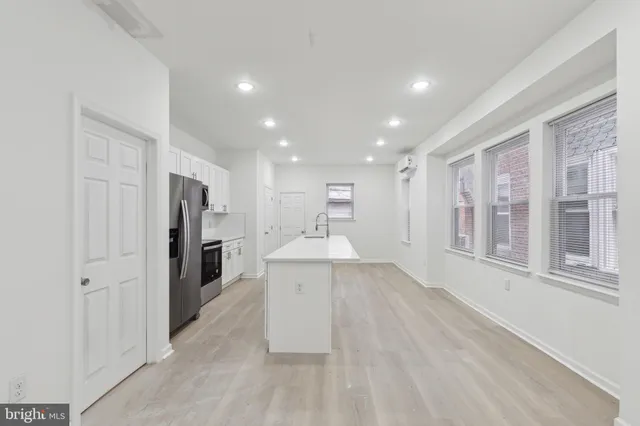 a view of a kitchen with a refrigerator and a sink