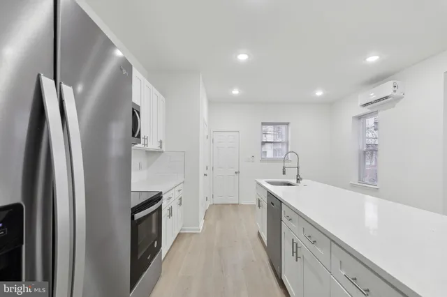 a kitchen with stainless steel appliances a sink stove and refrigerator