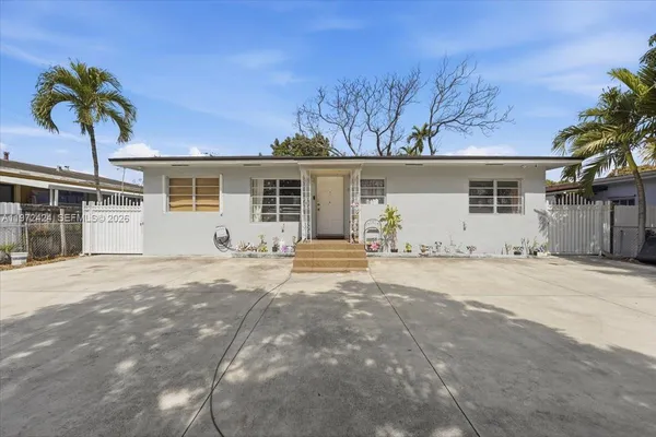a view of a house with a yard and garage