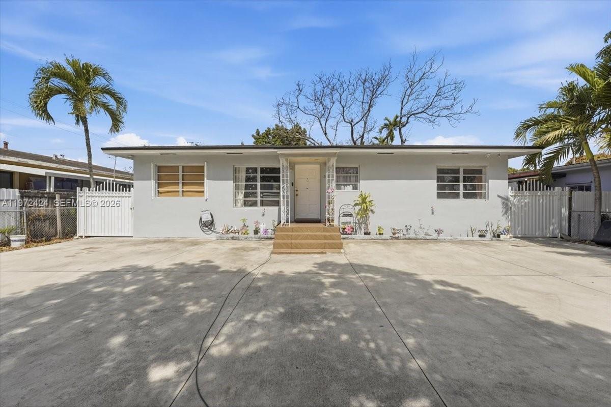 511 East 27th Street Hialeah, FL 33013 - Photo 1 of 24 a view of a house with a yard and garage