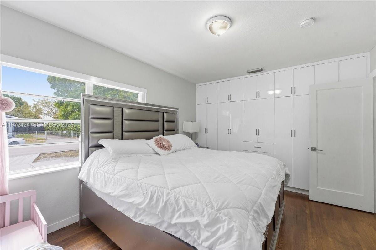 511 East 27th Street Hialeah, FL 33013 - Photo 11 of 24 a bedroom with a bed and a large window