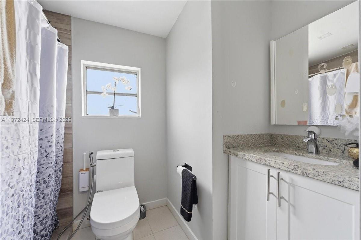 511 East 27th Street Hialeah, FL 33013 - Photo 19 of 24 a white toilet sitting next to a bathroom sink