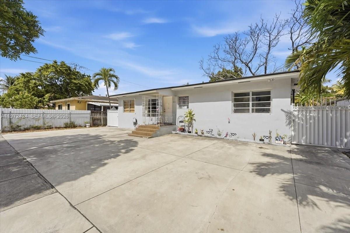 511 East 27th Street Hialeah, FL 33013 - Photo 2 of 24 a front view of a house with a yard and garage