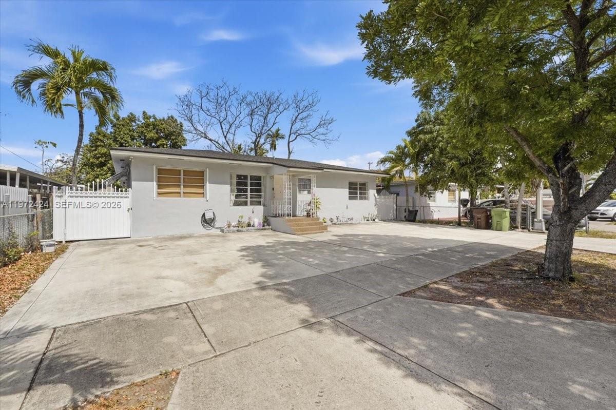 511 East 27th Street Hialeah, FL 33013 - Photo 3 of 24 a front view of a house with a yard and garage