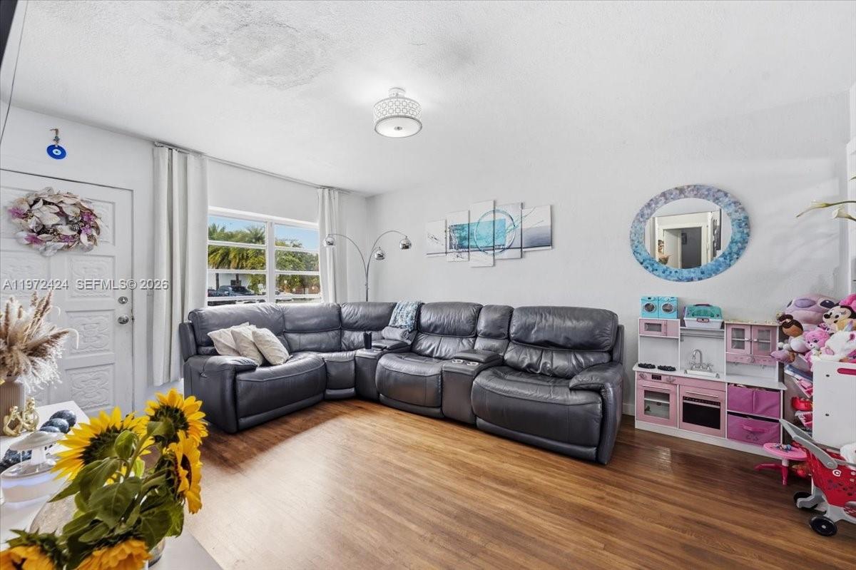 511 East 27th Street Hialeah, FL 33013 - Photo 4 of 24 a living room with furniture and a painting on the wall