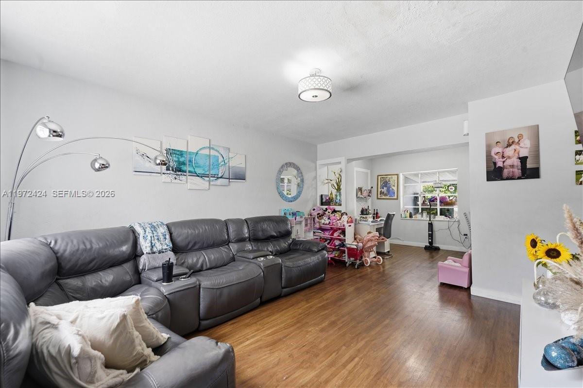 511 East 27th Street Hialeah, FL 33013 - Photo 5 of 24 a living room with furniture and a wooden floor