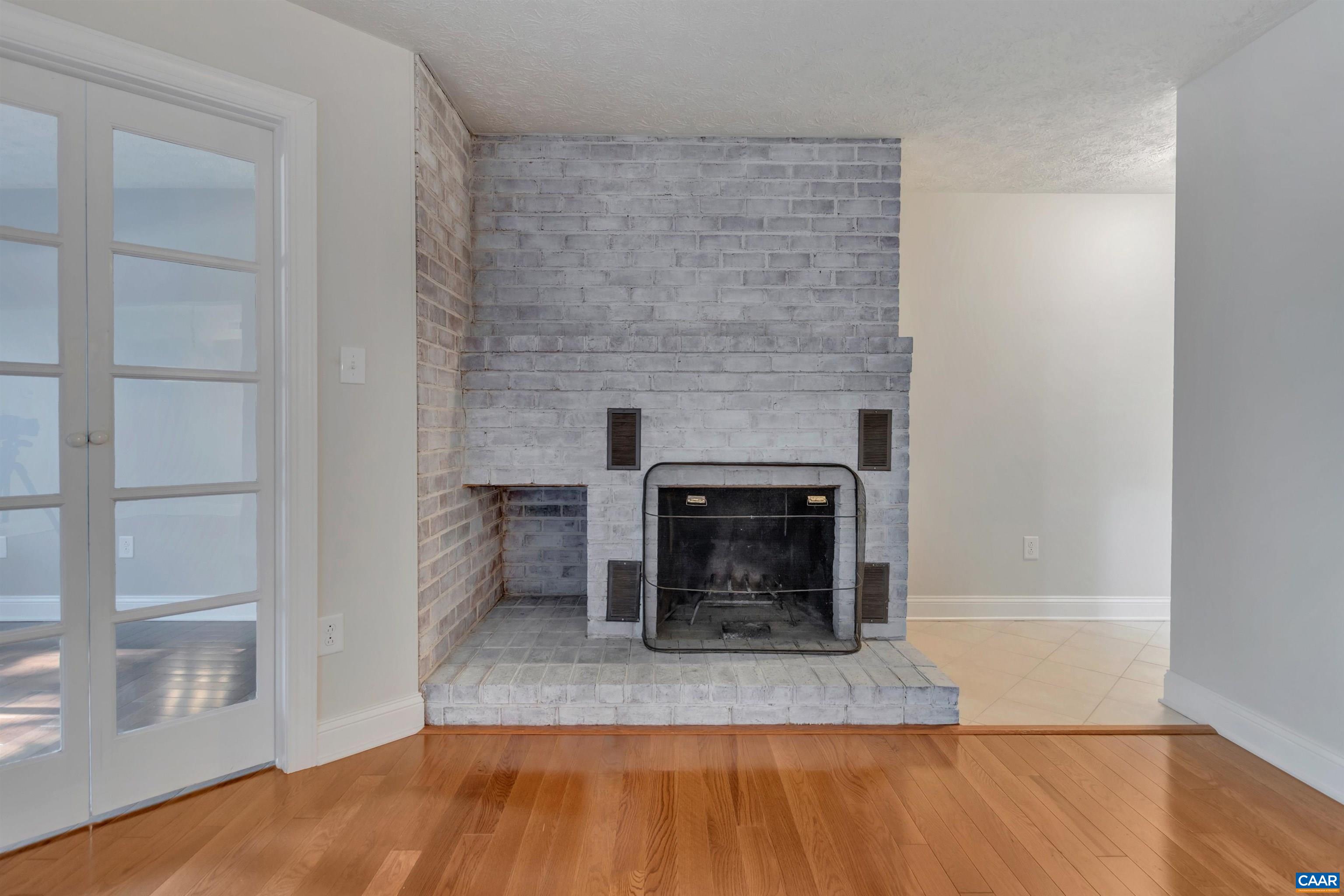 110 Turtle Creek Road Charlottesville, VA 22901 - Photo 5 of 44 a view of empty room with wooden floor and fireplace