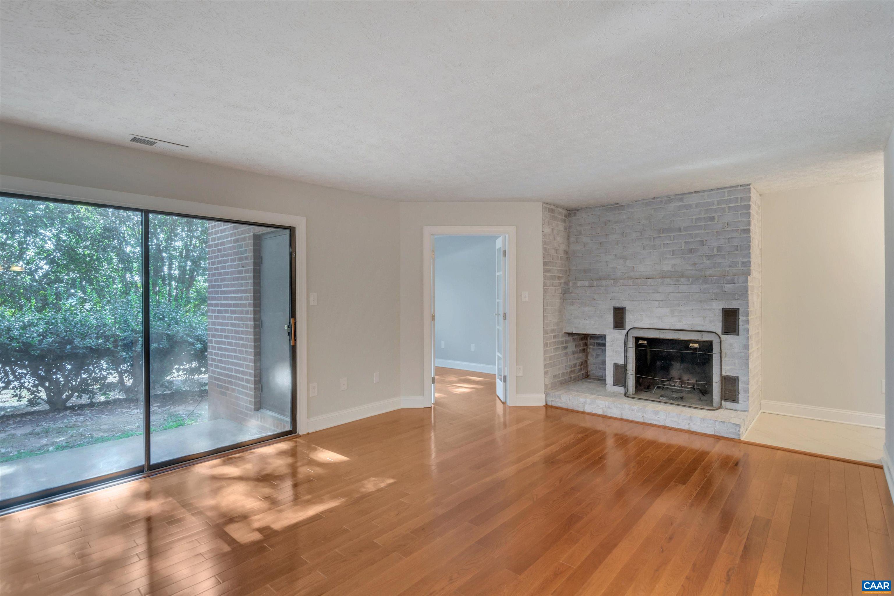 110 Turtle Creek Road Charlottesville, VA 22901 - Photo 6 of 44 a view of empty room with wooden floor and fireplace