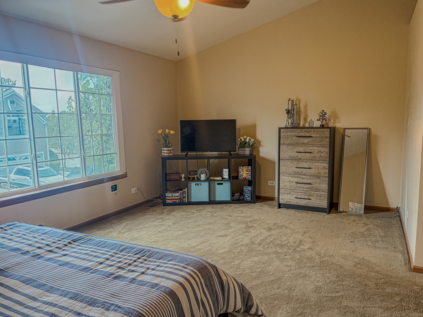 1567 Spaulding Road, Unit 1567 Bartlett, IL 60103 - Photo 11 of 13 a view of a bedroom with furniture and a flat screen tv