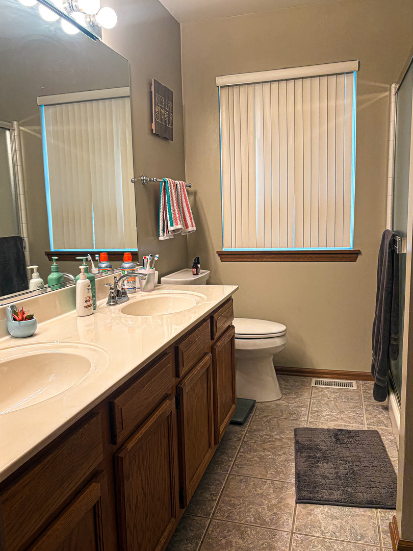 1567 Spaulding Road, Unit 1567 Bartlett, IL 60103 - Photo 12 of 13 a bathroom with a sink and a mirror