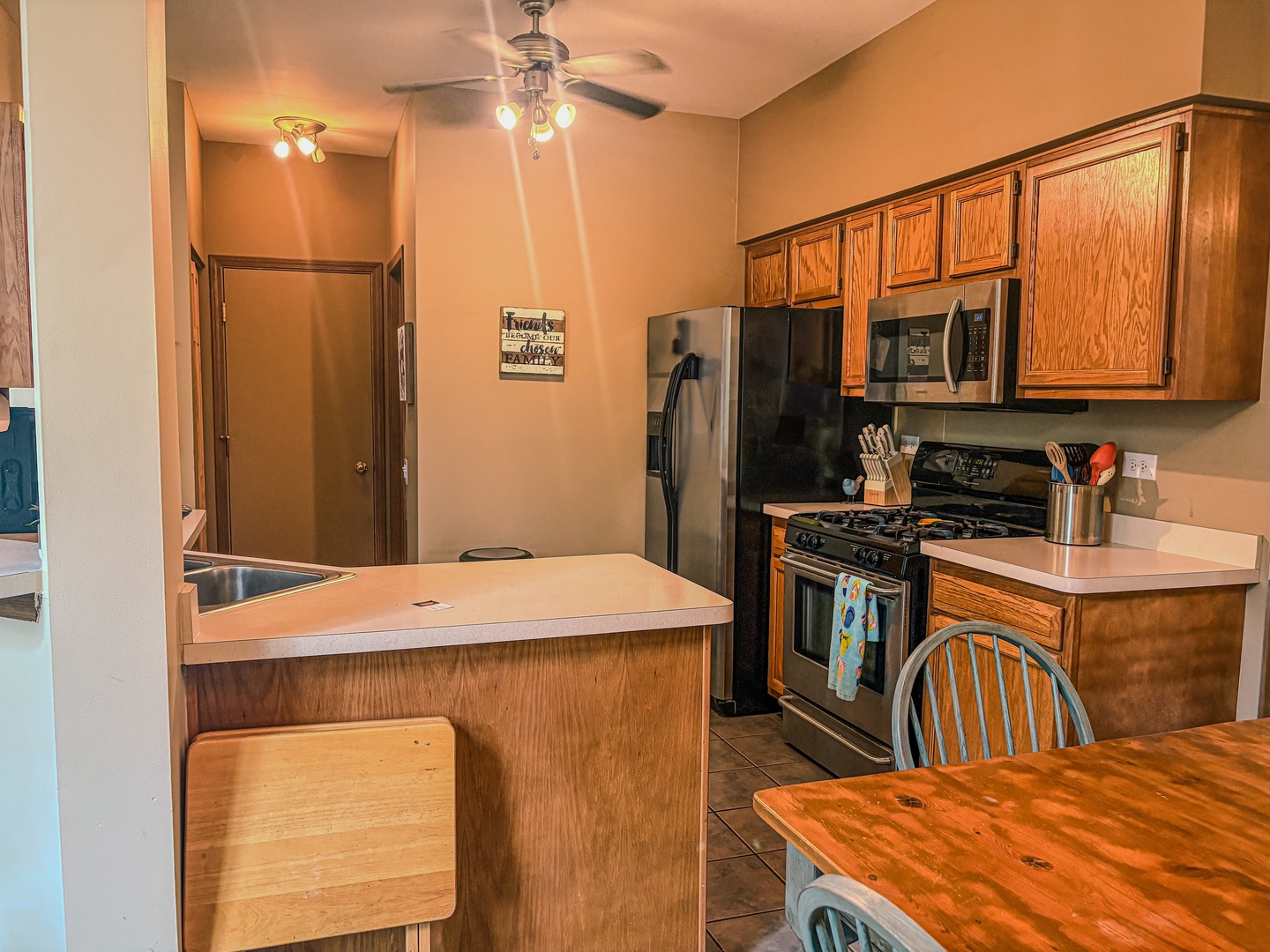 1567 Spaulding Road, Unit 1567 Bartlett, IL 60103 - Photo 6 of 13 a kitchen with stainless steel appliances kitchen island granite countertop a refrigerator a stove a sink dishwasher with a dining table and chairs