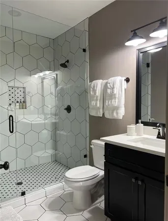 a bathroom with a sink toilet and shower
