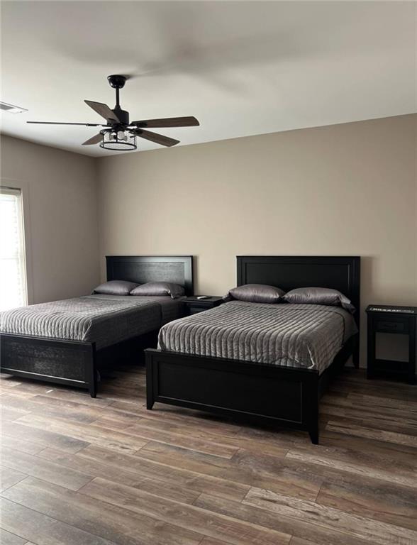 950 Island Shoals Road Jackson, GA 30233 - Photo 14 of 23 a bedroom with a bed and a ceiling fan