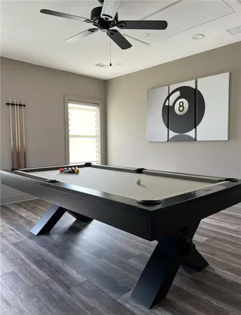 a room with pool table and window