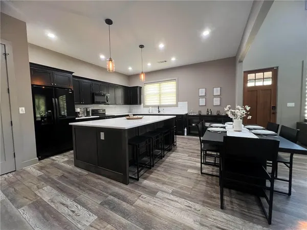 a large kitchen with a table and chairs