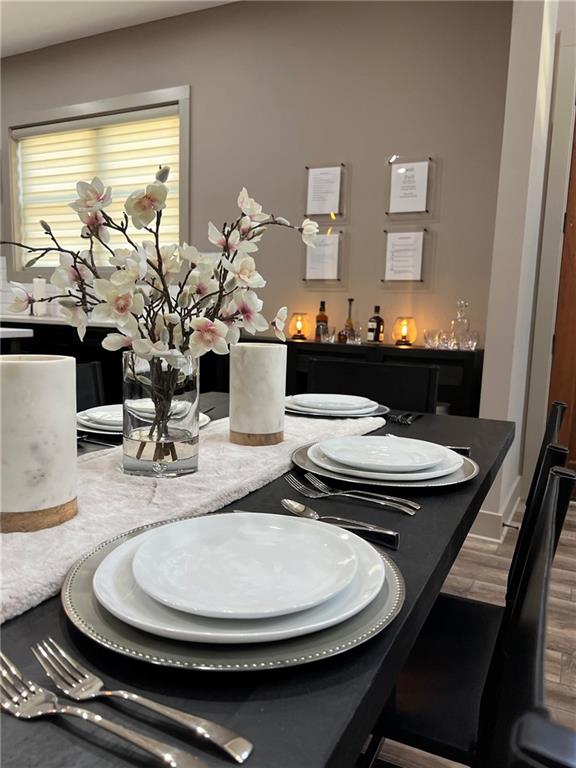 950 Island Shoals Road Jackson, GA 30233 - Photo 5 of 23 a dining room with furniture a potted plant and wooden floor