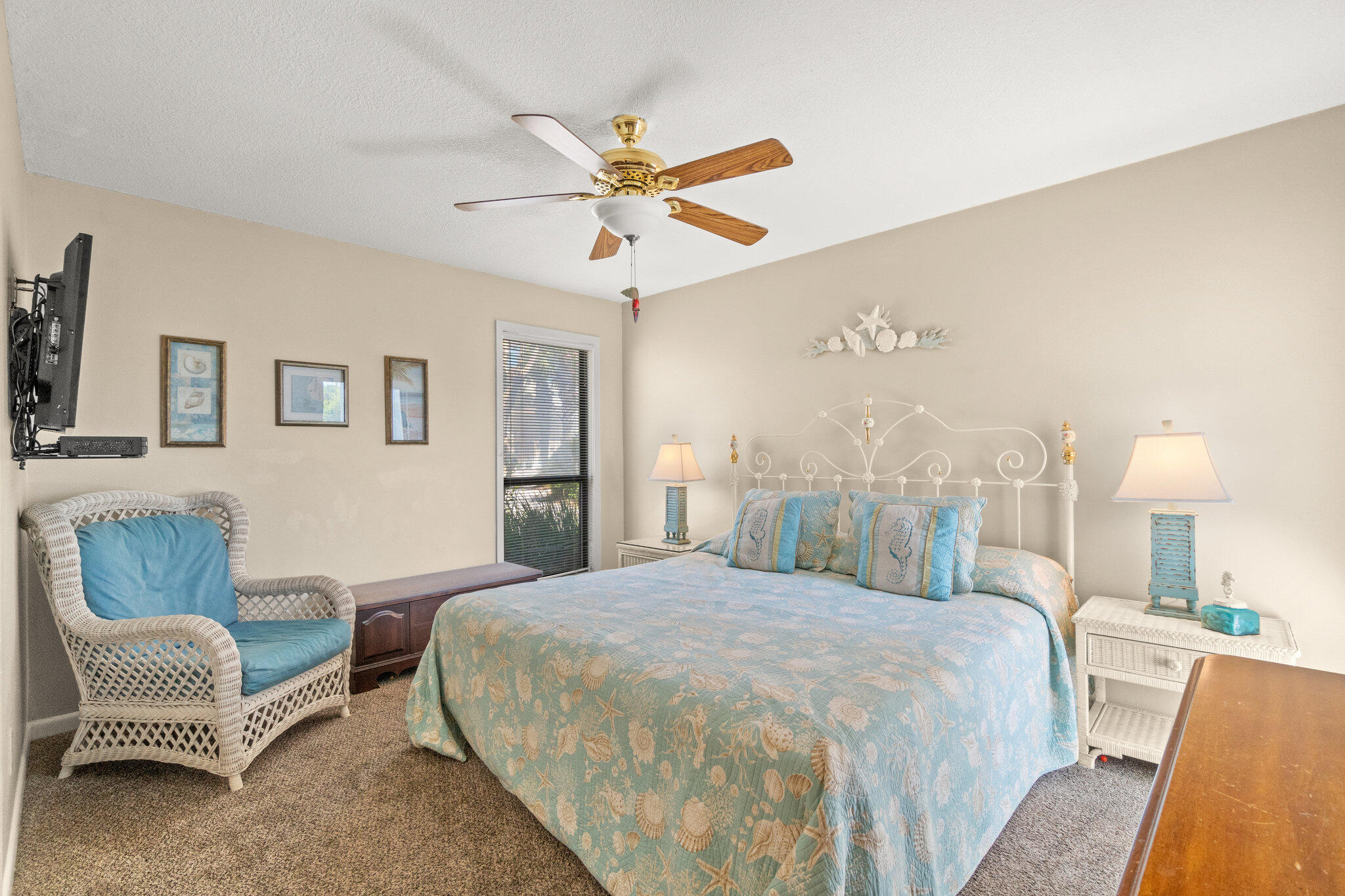 752 Sandpiper Drive, Unit 10535 Miramar Beach, FL 32550 - Photo 14 of 32 a spacious bedroom with a bed a couch and a chandelier