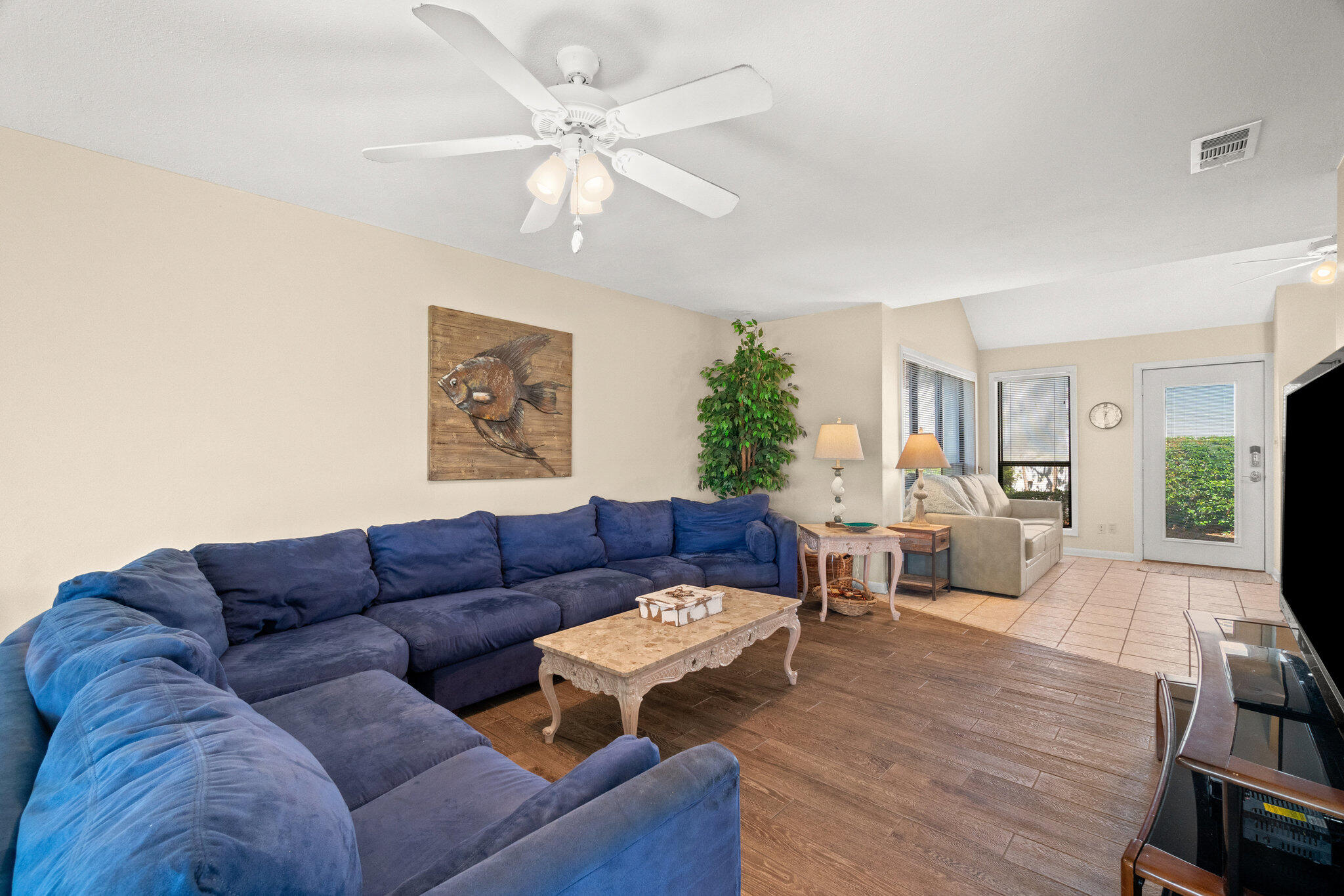 752 Sandpiper Drive, Unit 10535 Miramar Beach, FL 32550 - Photo 8 of 32 a living room with furniture a large window and a chandelier