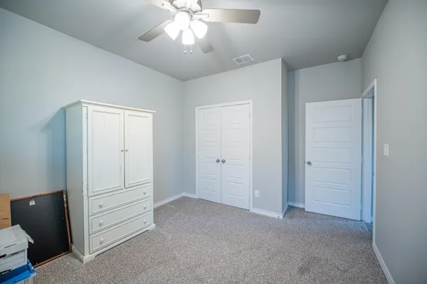 a view of an empty room and closet area