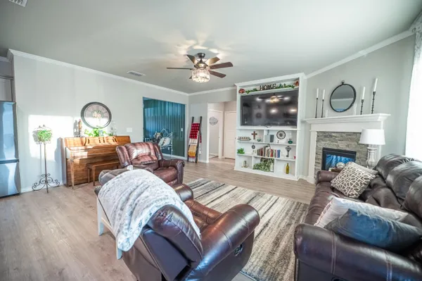 a living room with furniture a fireplace and a flat screen tv