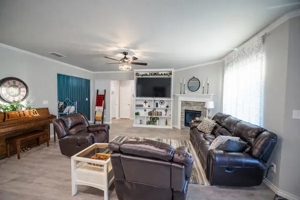 a living room with furniture a fireplace and a flat screen tv