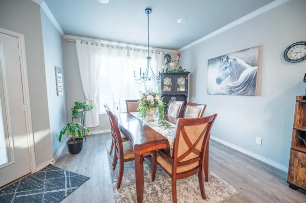 a dining room with furniture and wooden floor