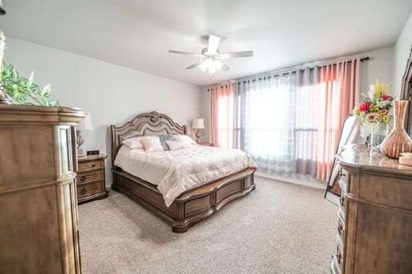 a bedroom with a bed dresser and a window
