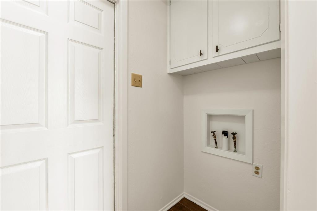 141 Travis Lane Hewitt, TX 76643 - Photo 22 of 31 Laundry area with upper cabinetry and a recessed wall box for washer hookups