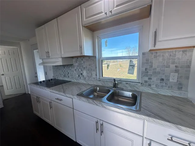 a kitchen with a sink and cabinets