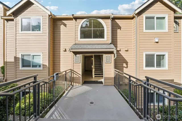 a view of a house with wooden fence