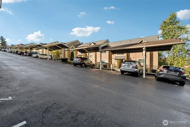 a view of a cars park in front of a house