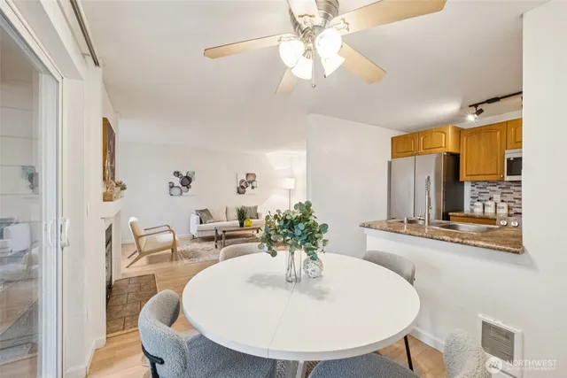 a dining room with furniture a chandelier and wooden floor