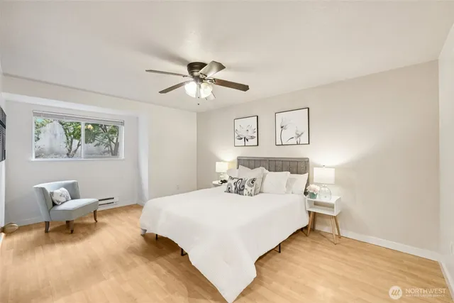 a bedroom with a large bed and a chandelier
