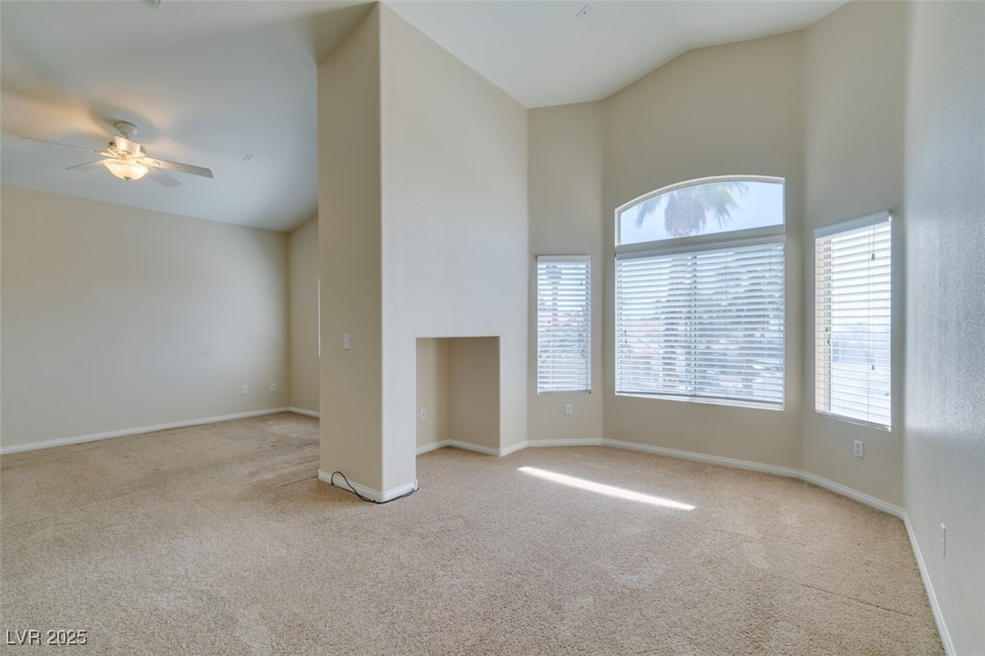 3766 Port Ritchey Street Las Vegas, NV 89147 - Photo 17 of 26 Carpeted spare room featuring high vaulted ceiling
