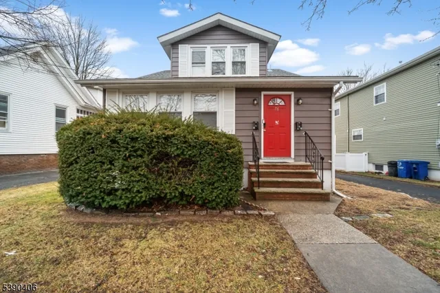 a front view of a house with garden