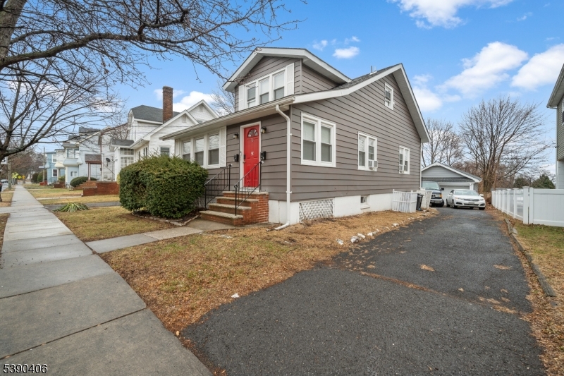 76 Van Ness Terrace, Unit 2 Maplewood, NJ 07040 - Photo 2 of 9 a front view of a house with a yard and garage