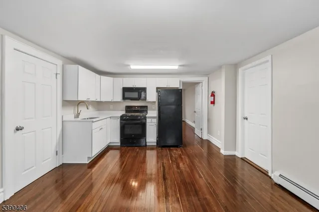 a kitchen with wooden floors and appliances